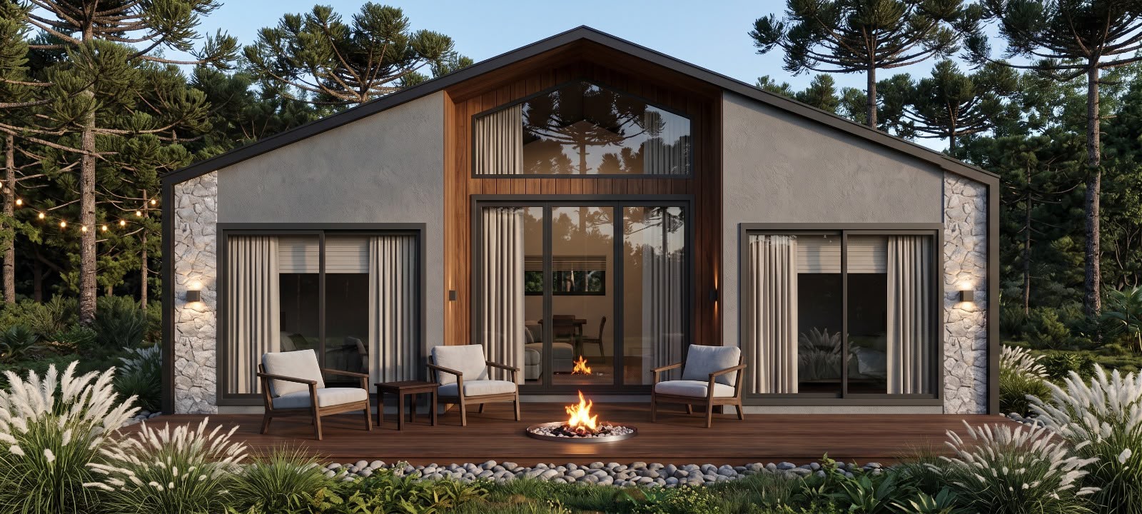 Cabana Altos da Montanha — fachada principal ao entardecer, com deck de madeira, poltronas, lareira de chão acesa e mata de araucárias ao fundo